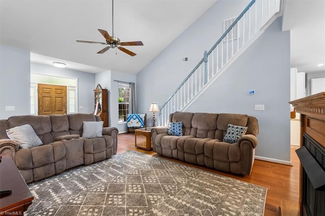 3702 Belfry Ct, Greensboro, NC 27410 - living room with a ceiling fan, wood finished floors, stairs, high vaulted ceiling, and baseboards