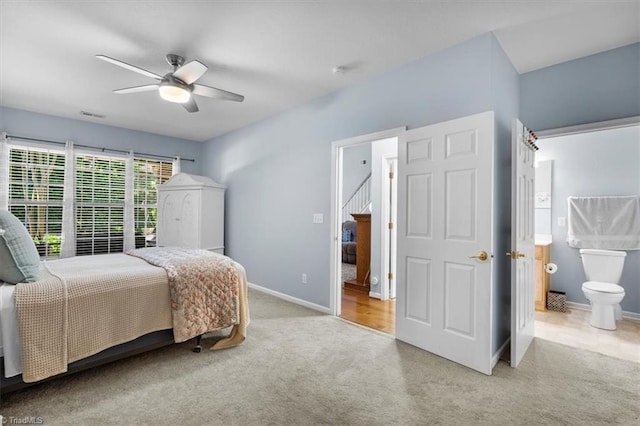3702 Belfry Ct, Greensboro, NC 27410 - carpeted bedroom featuring baseboards, ensuite bathroom, and a ceiling fan