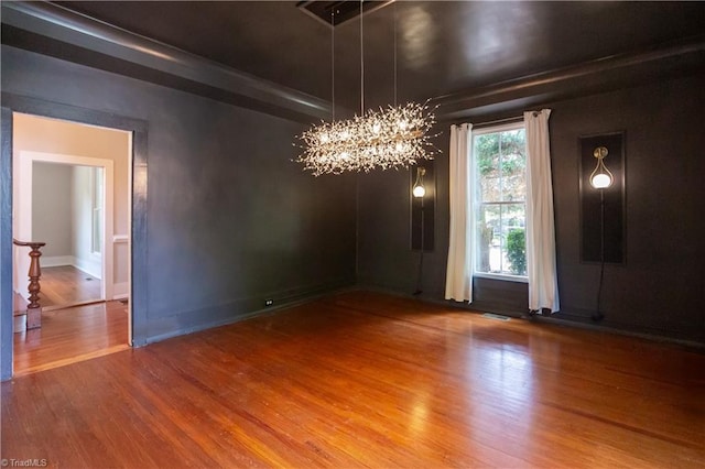 627 Mulberry St, Winston-Salem, NC 27101 - unfurnished dining area with a chandelier and wood finished floors