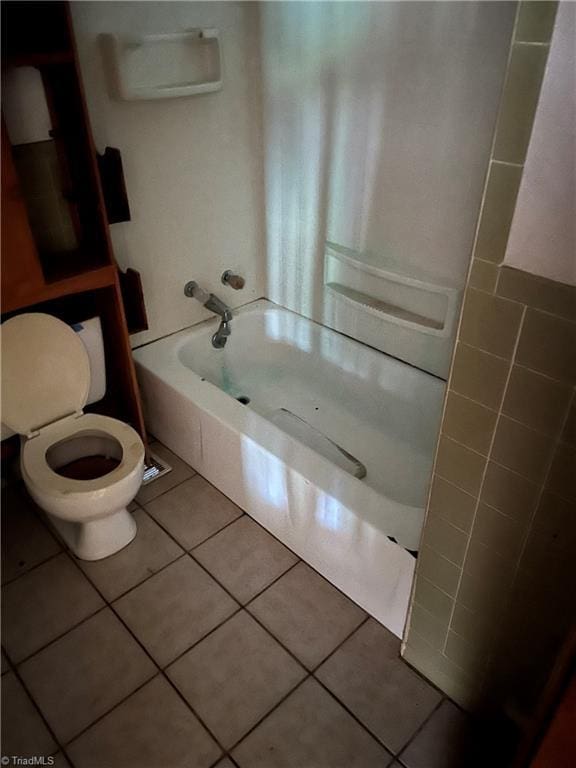 bathroom featuring shower / bath combination, tile patterned floors, and toilet