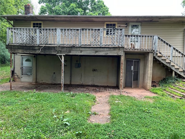 rear view of property featuring a wooden deck