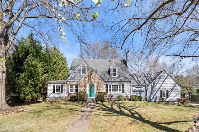 cape cod house featuring stone siding, a chimney, and a front lawn