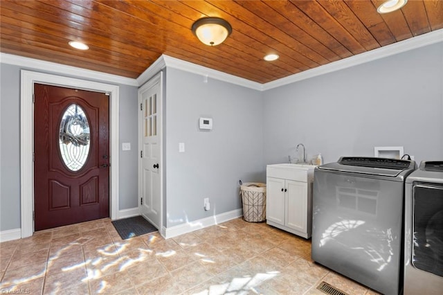 laundry room featuring ornamental molding, a sink, cabinet space, separate washer and dryer, and wood ceiling