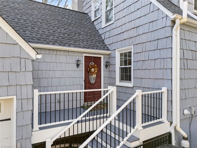 entrance to property with a shingled roof