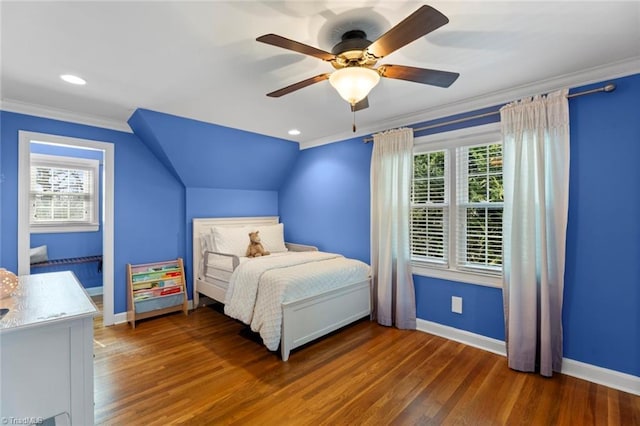 bedroom with baseboards, wood finished floors, vaulted ceiling, and ornamental molding