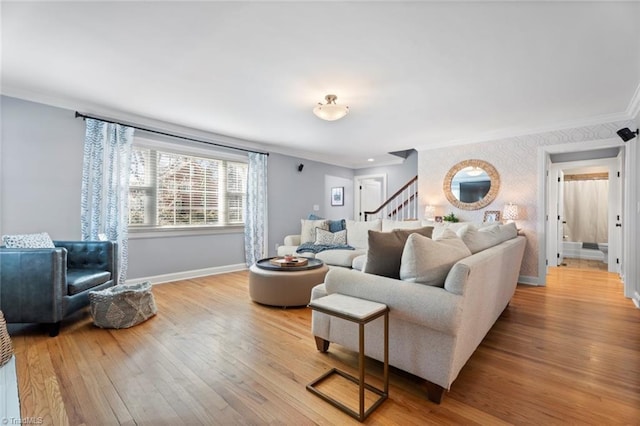 living area with light wood finished floors, crown molding, and baseboards