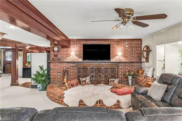 carpeted living room featuring brick wall and ceiling fan