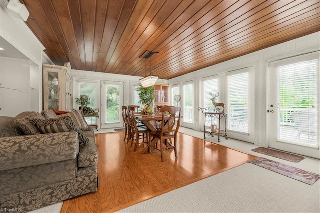 living room with a wealth of natural light, wood-type flooring, and wood ceiling