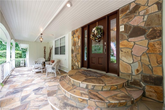 doorway to property featuring covered porch