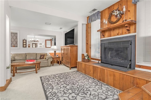 living room featuring a notable chandelier and light colored carpet