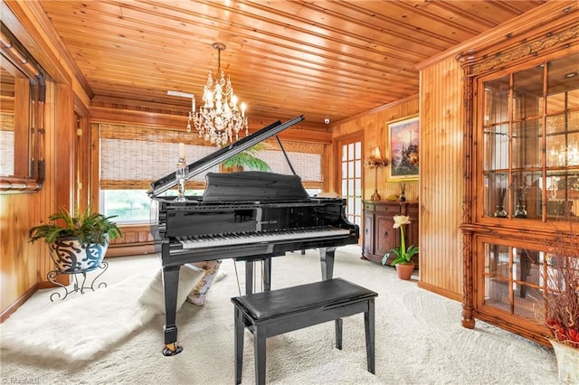 misc room featuring wood walls, a notable chandelier, carpet, and wooden ceiling