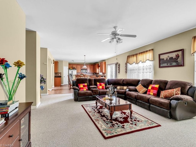 living room featuring light carpet and ceiling fan