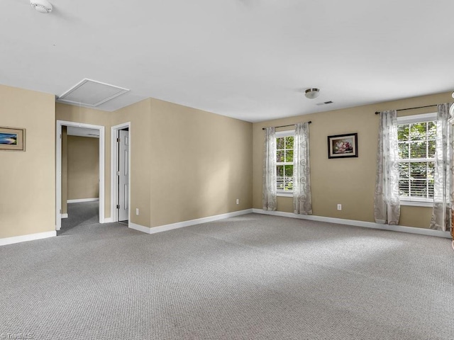 carpeted empty room with plenty of natural light