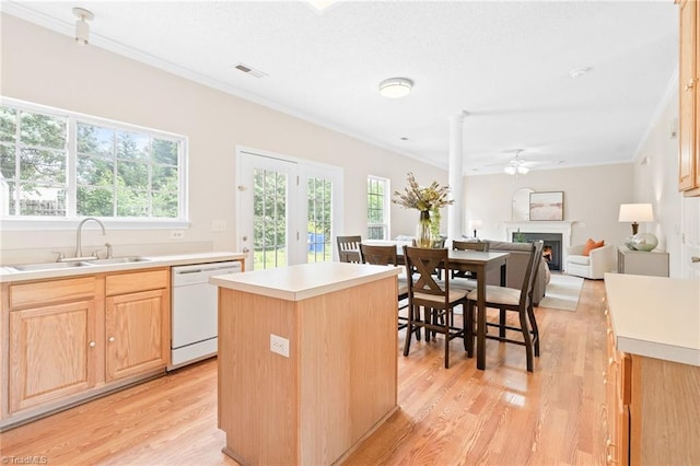 7 Pilot Ridge Ct, Greensboro, NC 27407 - kitchen featuring white dishwasher, ornamental molding, light brown cabinets, a sink, and light wood-style flooring