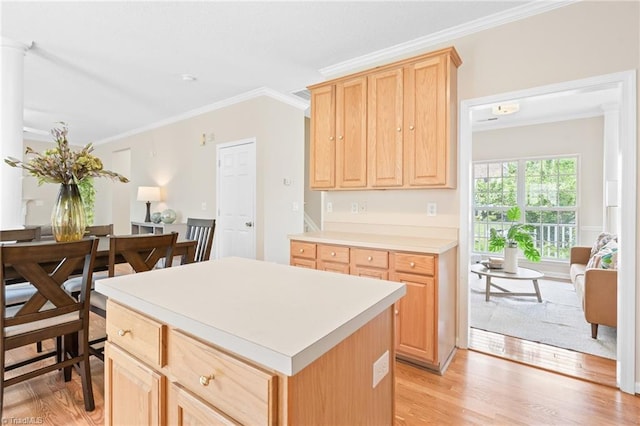 7 Pilot Ridge Ct, Greensboro, NC 27407 - kitchen featuring light brown cabinets, ornamental molding, light wood-style flooring, light countertops, and a center island