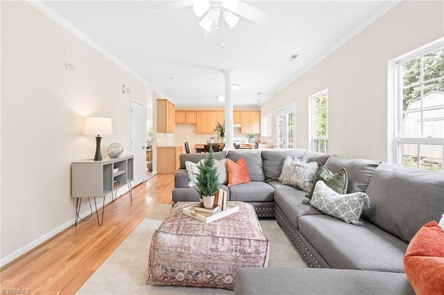7 Pilot Ridge Ct, Greensboro, NC 27407 - living room featuring ornamental molding, plenty of natural light, light wood finished floors, a ceiling fan, and decorative columns