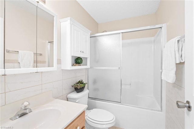 7 Pilot Ridge Ct, Greensboro, NC 27407 - bathroom with vanity, toilet, tile walls, combined bath / shower with glass door, and backsplash