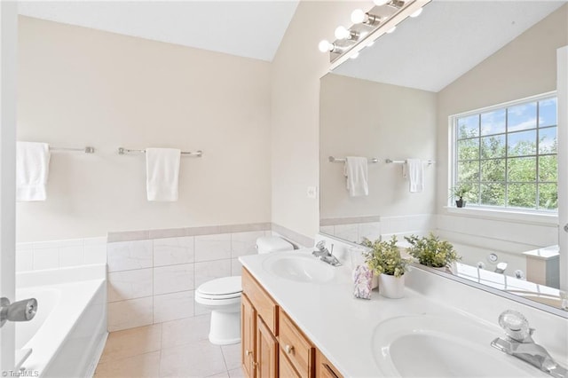 7 Pilot Ridge Ct, Greensboro, NC 27407 - bathroom with vaulted ceiling, double vanity, a bath, tile patterned floors, and toilet
