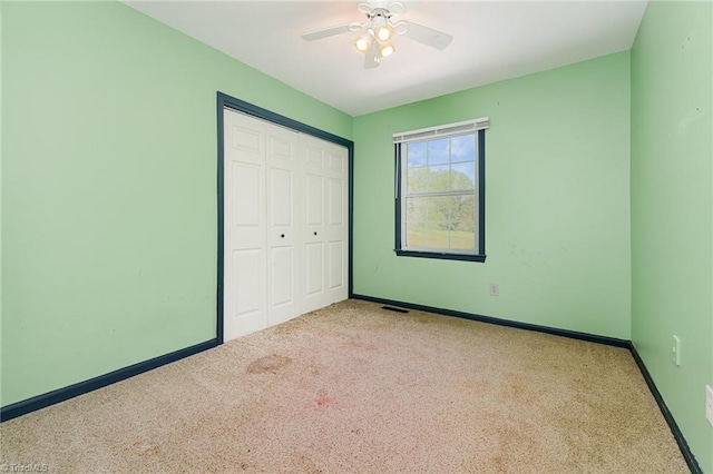 unfurnished bedroom with a closet, carpet flooring, baseboards, and visible vents