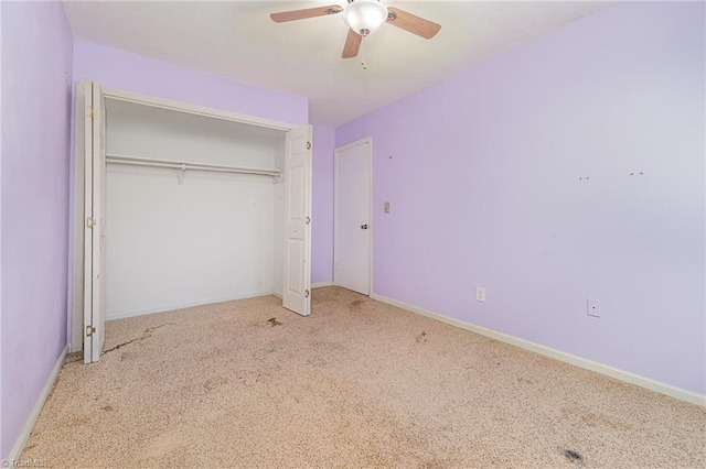 unfurnished bedroom with a closet, baseboards, a ceiling fan, and carpet
