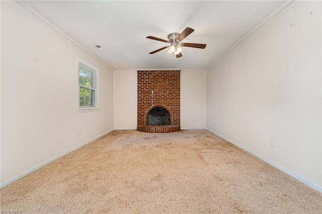 unfurnished living room featuring visible vents, a brick fireplace, ornamental molding, a ceiling fan, and carpet