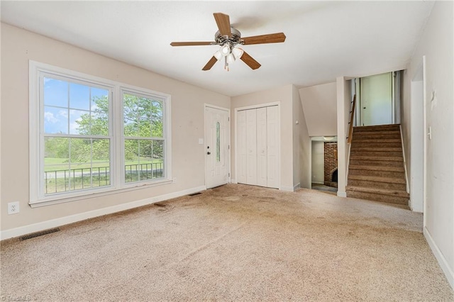 unfurnished living room with stairway, visible vents, baseboards, and carpet floors