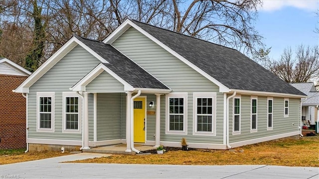 view of front of property featuring covered porch and roof with shingles