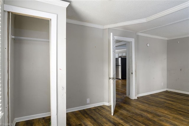 unfurnished bedroom with crown molding, a textured ceiling, wood finished floors, and freestanding refrigerator