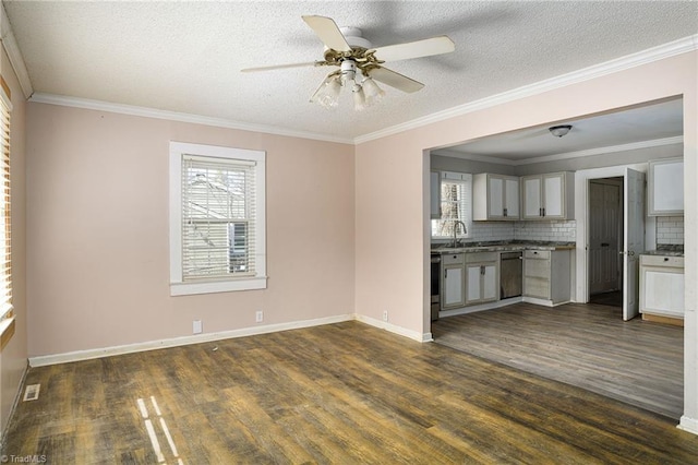 interior space featuring baseboards, ornamental molding, and dark wood finished floors