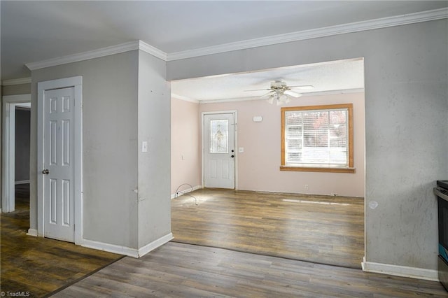 foyer featuring crown molding, a ceiling fan, plenty of natural light, and wood finished floors