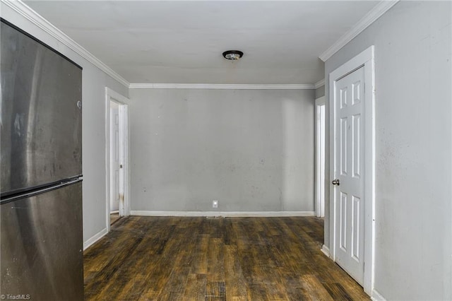 unfurnished dining area featuring ornamental molding, baseboards, and hardwood / wood-style floors