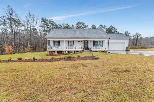 ranch-style house with a garage, a front yard, and covered porch