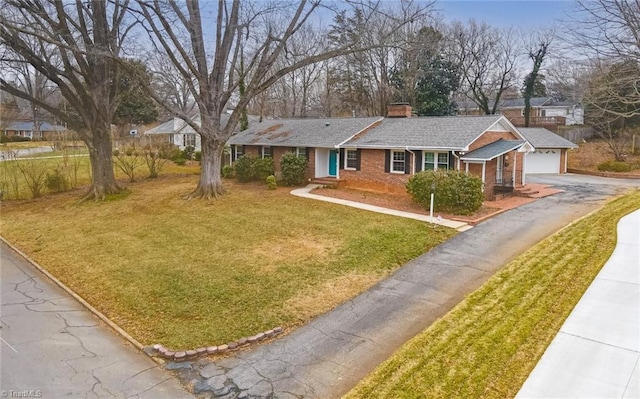 single story home featuring a garage and a front yard