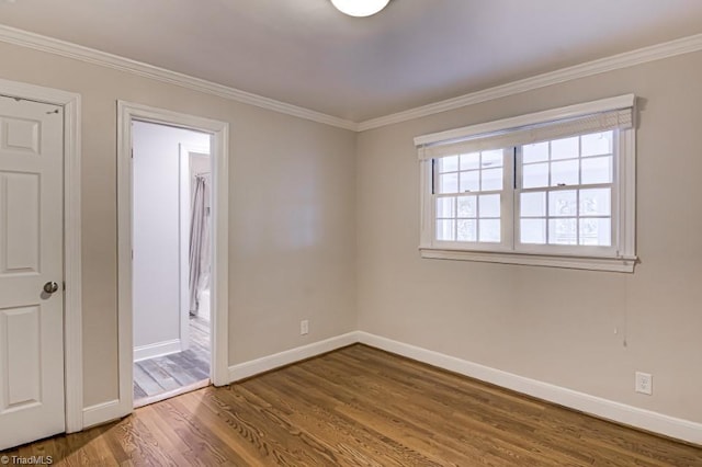 unfurnished room featuring ornamental molding and wood-type flooring