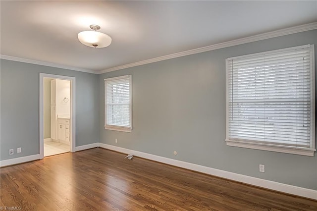 unfurnished bedroom with hardwood / wood-style floors, crown molding, and ensuite bathroom