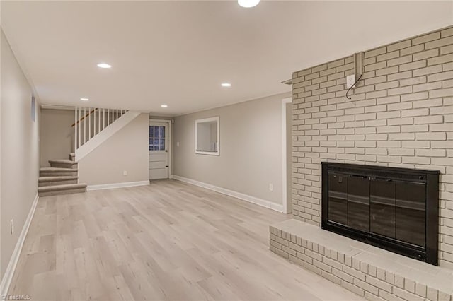 unfurnished living room with a fireplace and light wood-type flooring