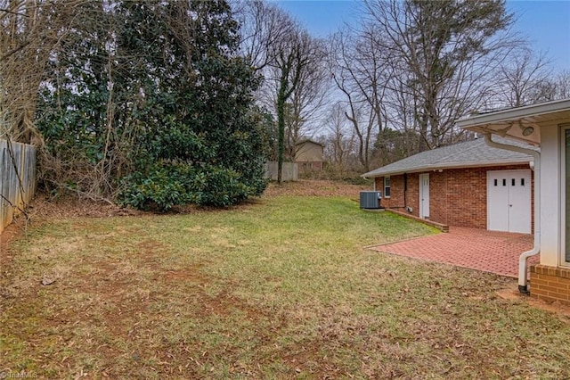 view of yard with central AC unit and a patio