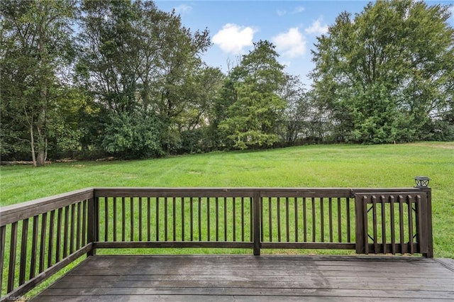 wooden deck featuring a yard