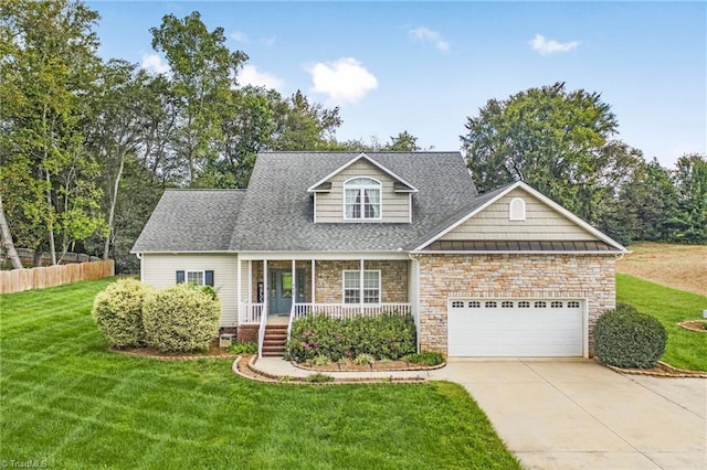 view of front facade featuring a garage, a front lawn, and a porch