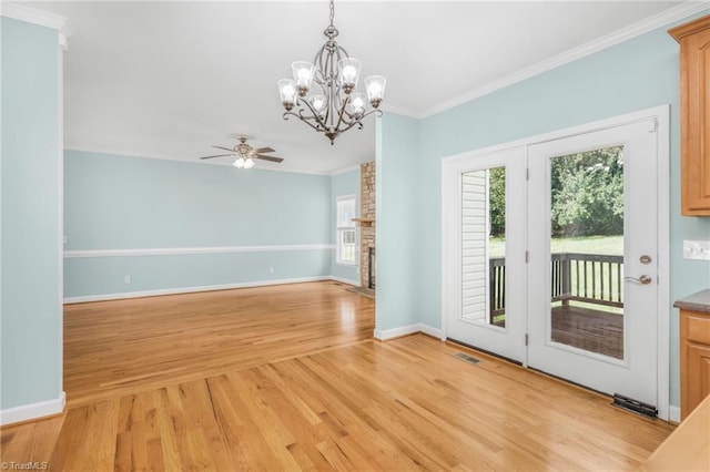 interior space with ceiling fan with notable chandelier, light wood-type flooring, and ornamental molding