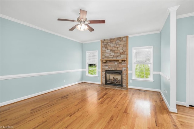 unfurnished living room featuring light wood-type flooring, ceiling fan, plenty of natural light, and a fireplace