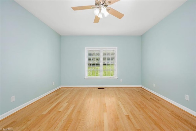 spare room featuring hardwood / wood-style floors and ceiling fan