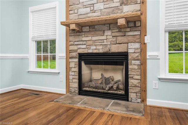 interior details featuring hardwood / wood-style floors and a fireplace