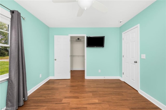 unfurnished bedroom featuring ceiling fan, a closet, and hardwood / wood-style floors