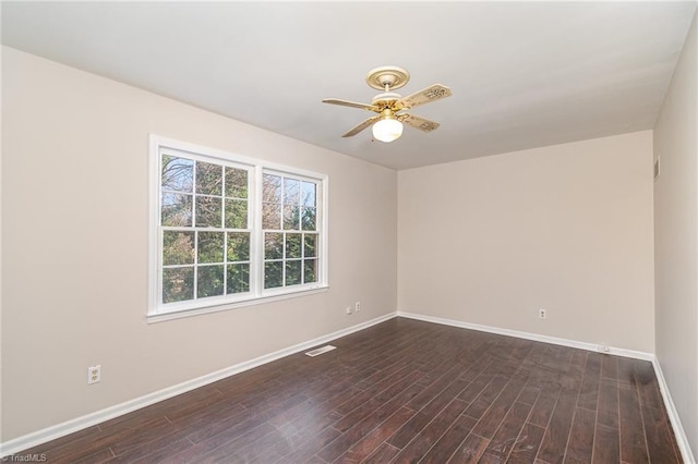 empty room with a ceiling fan, dark wood-style flooring, visible vents, and baseboards