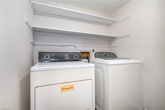 washroom with washing machine and dryer and laundry area