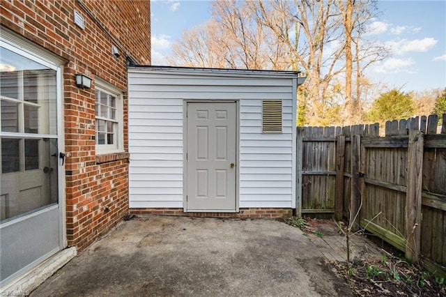 view of outbuilding featuring fence