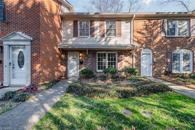 view of front of home featuring brick siding