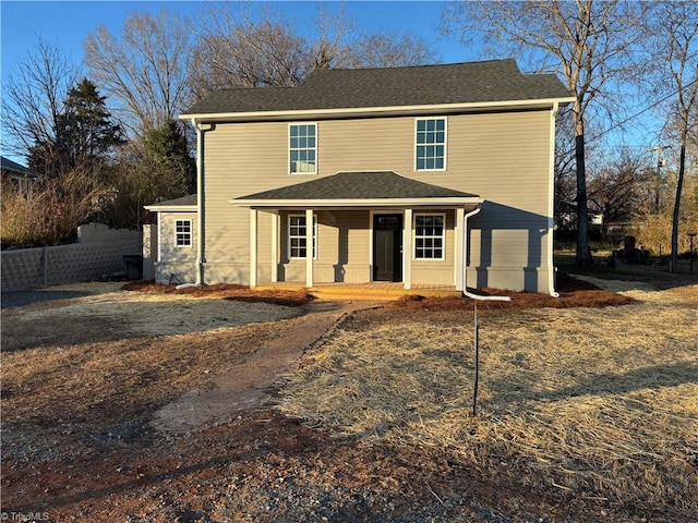 view of property featuring a porch and a garage