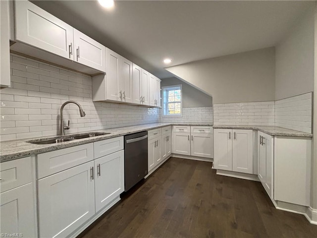 kitchen with stainless steel dishwasher, white cabinetry, and sink